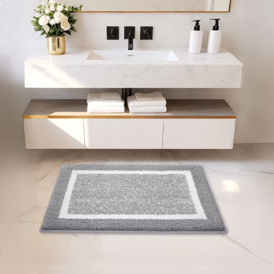 Bathroom with a gray rug on the floor, white sink, and decorative elements.